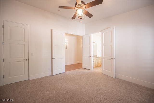 unfurnished bedroom with ceiling fan and light carpet