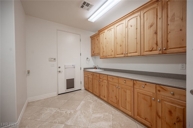 kitchen with sink and light tile patterned floors