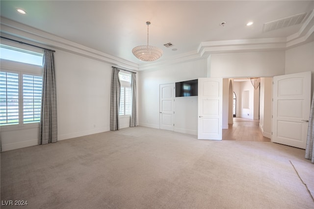 unfurnished bedroom with crown molding and light carpet