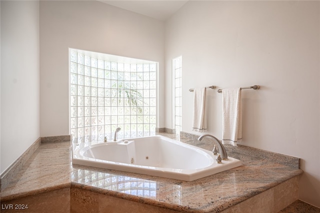 bathroom with tiled tub