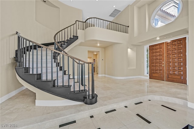 entryway with a high ceiling and a healthy amount of sunlight