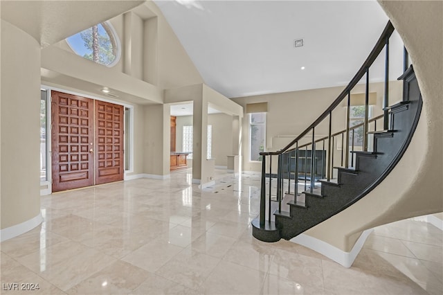 entrance foyer featuring a towering ceiling