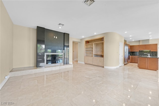 unfurnished living room featuring built in features