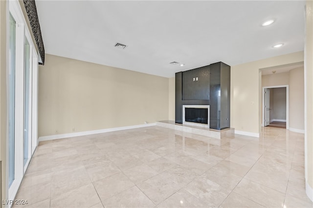 unfurnished living room with a large fireplace