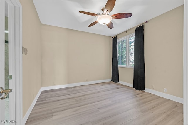 unfurnished room with light wood-type flooring and ceiling fan