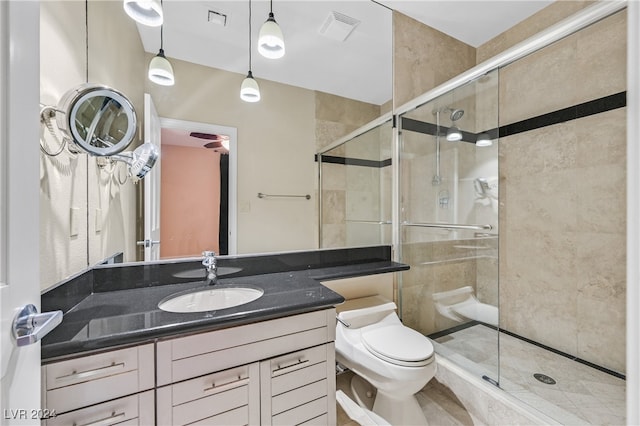 bathroom with vanity, toilet, and an enclosed shower