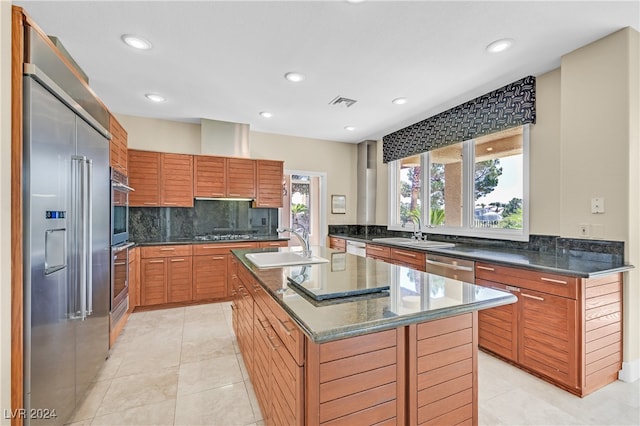 kitchen featuring an island with sink, plenty of natural light, and sink