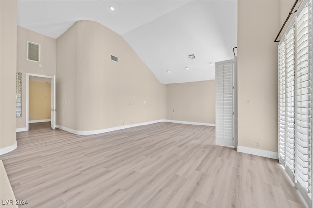 interior space featuring light hardwood / wood-style flooring and high vaulted ceiling