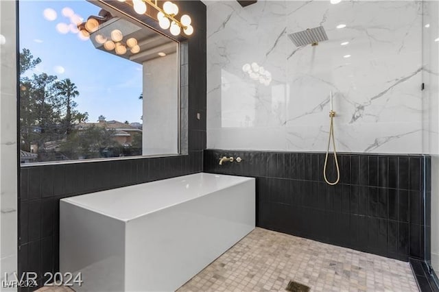 bathroom featuring tile walls and walk in shower