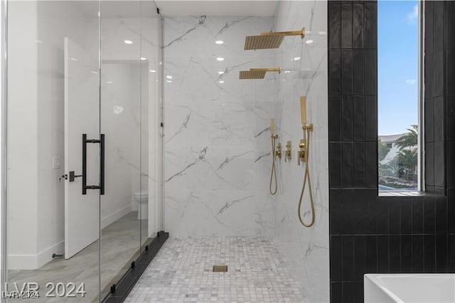 bathroom with a shower with shower door