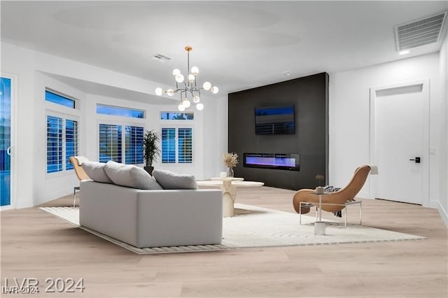 living room featuring light hardwood / wood-style flooring and a chandelier