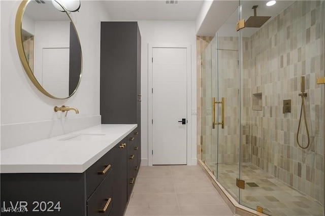 bathroom featuring tile patterned floors, walk in shower, and vanity