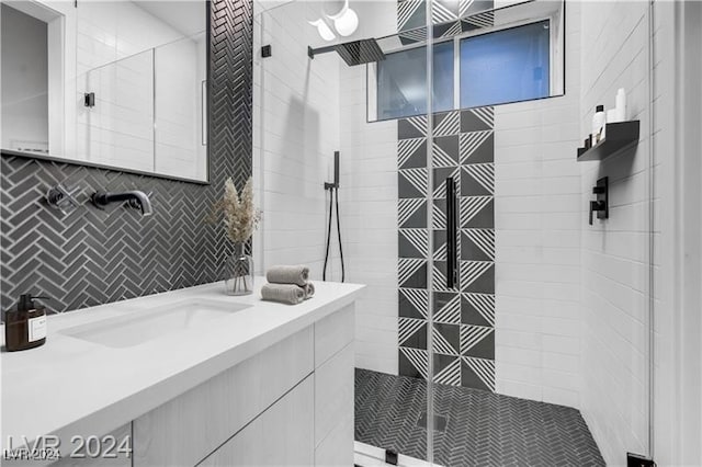 bathroom featuring tile walls, vanity, and tiled shower