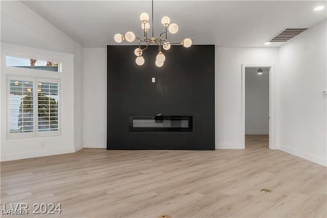 interior space featuring light hardwood / wood-style floors and an inviting chandelier