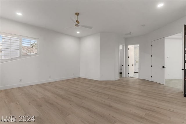 unfurnished room with light wood-type flooring and ceiling fan