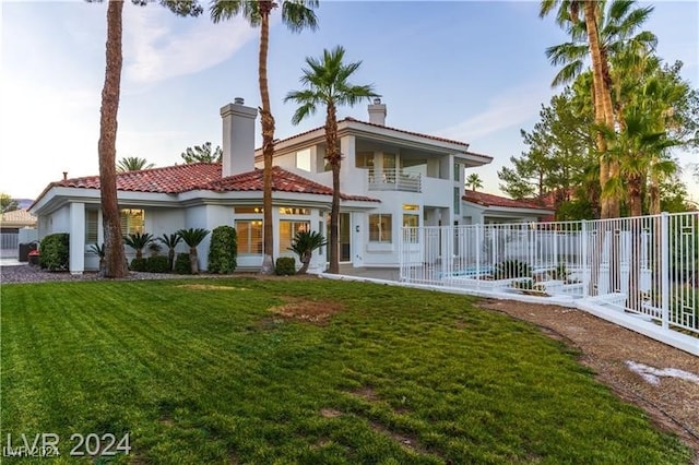 rear view of property with a patio and a yard