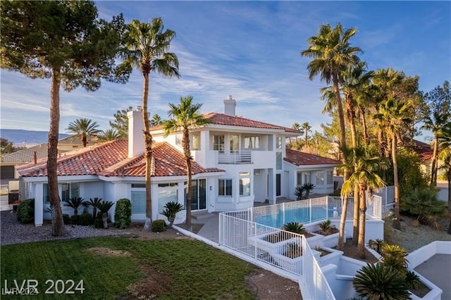 back of property with a patio and a balcony