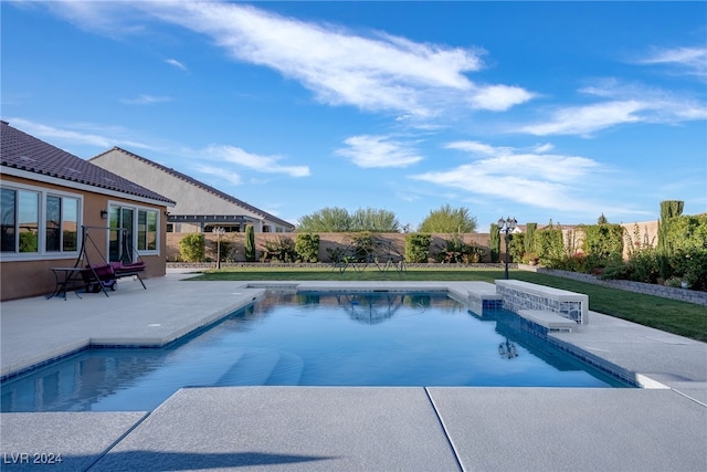 view of swimming pool featuring a patio