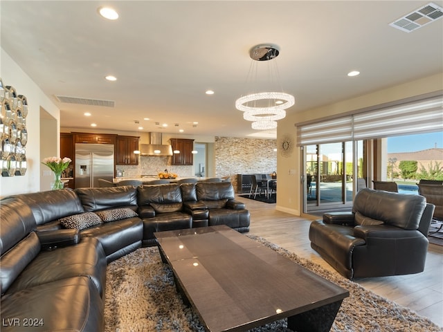 living room featuring light hardwood / wood-style floors and an inviting chandelier