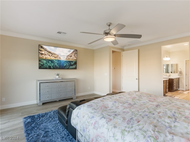 bedroom featuring ceiling fan, crown molding, ensuite bathroom, and light hardwood / wood-style flooring