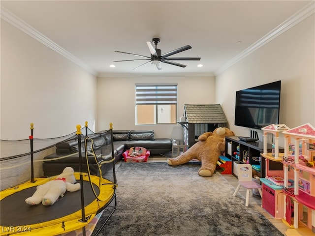 rec room with crown molding and ceiling fan