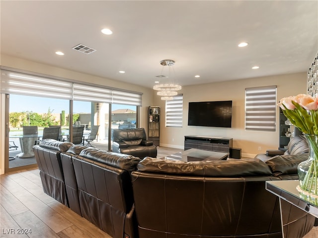 living room featuring a notable chandelier and light hardwood / wood-style floors