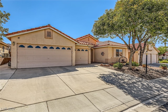 mediterranean / spanish-style home with a garage