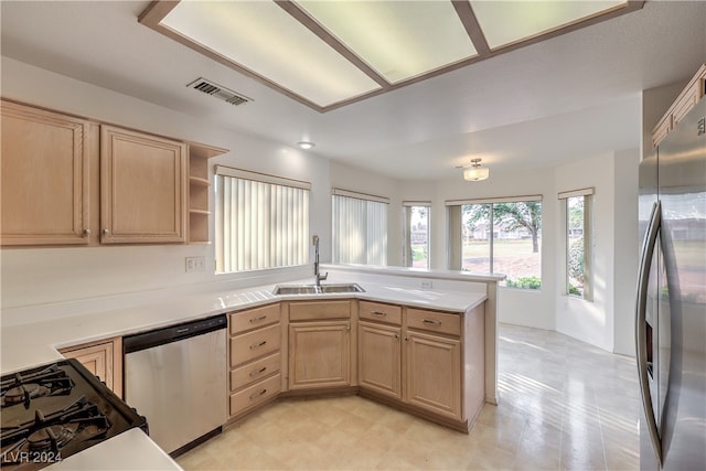 kitchen featuring light brown cabinets, appliances with stainless steel finishes, sink, and kitchen peninsula