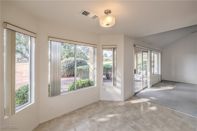 interior space featuring vaulted ceiling and a healthy amount of sunlight