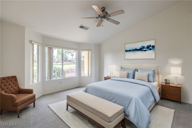 bedroom featuring ceiling fan, lofted ceiling, and light carpet