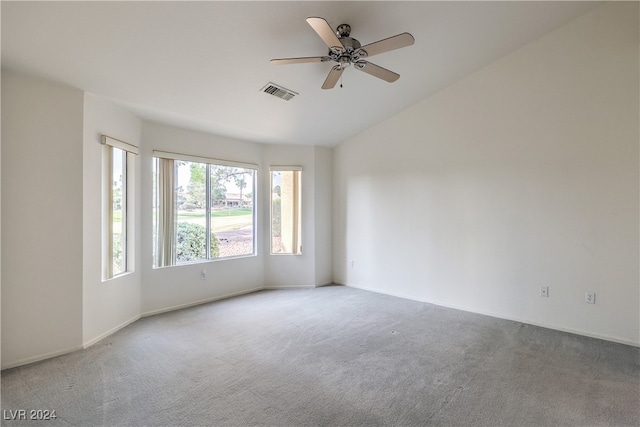 carpeted spare room with ceiling fan