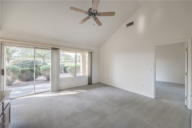 unfurnished room with ceiling fan, light colored carpet, and high vaulted ceiling