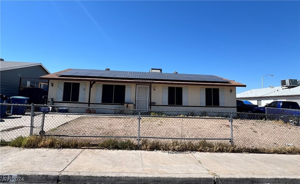 view of front of home featuring solar panels and a porch