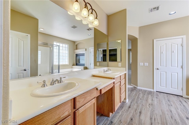 bathroom featuring vanity, hardwood / wood-style floors, and an enclosed shower