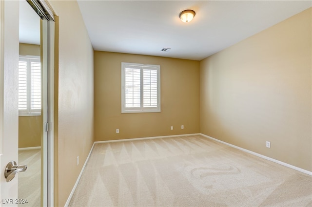 carpeted spare room with a wealth of natural light