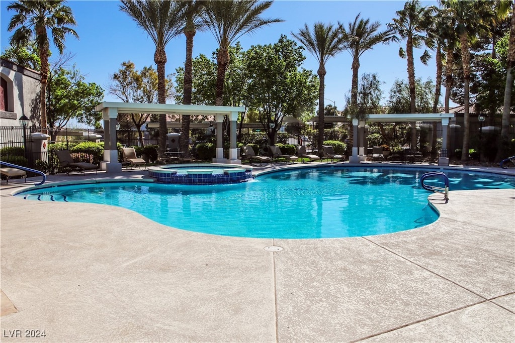 view of swimming pool with an in ground hot tub and a patio