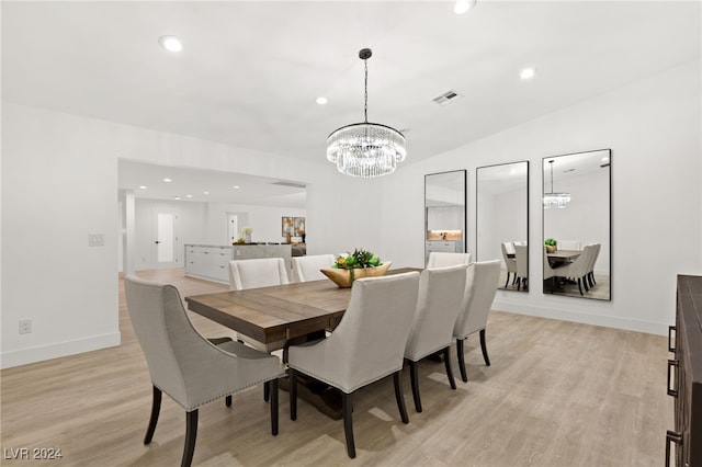 dining area with light wood-type flooring and lofted ceiling