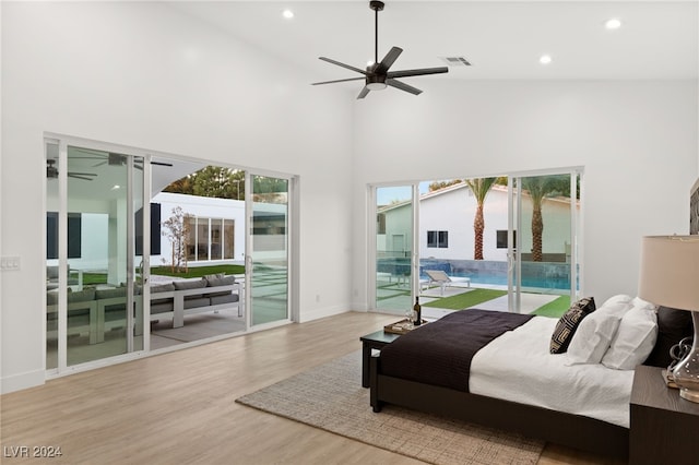 bedroom with high vaulted ceiling, light hardwood / wood-style floors, ceiling fan, and access to exterior