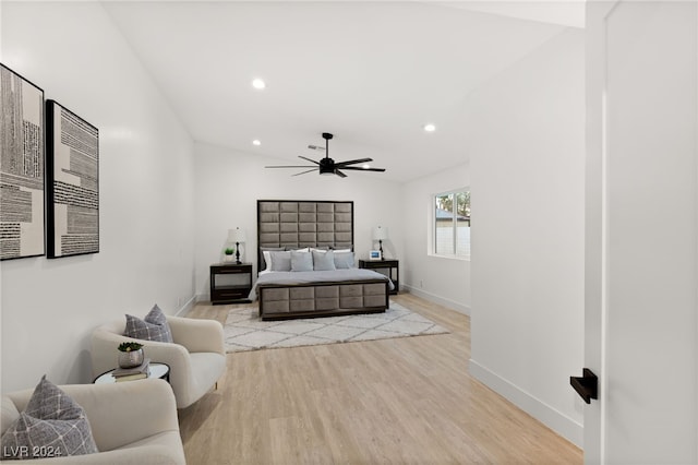 bedroom featuring light hardwood / wood-style flooring, lofted ceiling, and ceiling fan