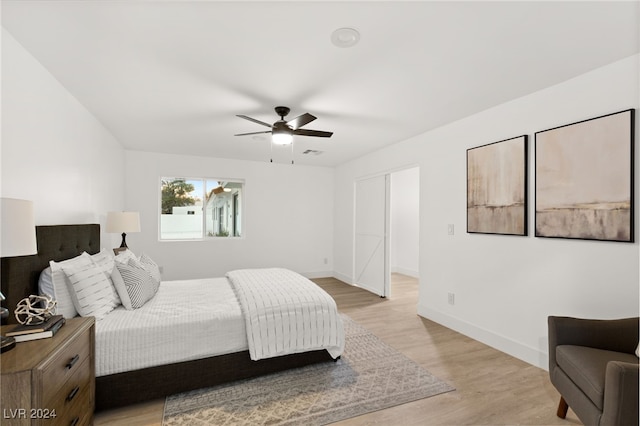 bedroom featuring light wood-type flooring and ceiling fan