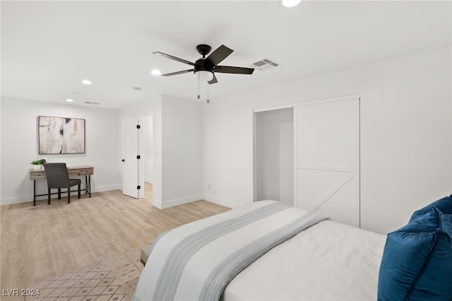 bedroom with light hardwood / wood-style flooring and ceiling fan