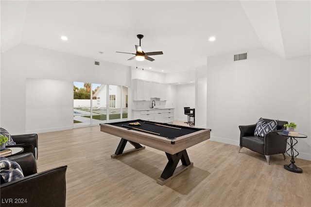 rec room featuring light wood-type flooring, pool table, sink, vaulted ceiling, and ceiling fan