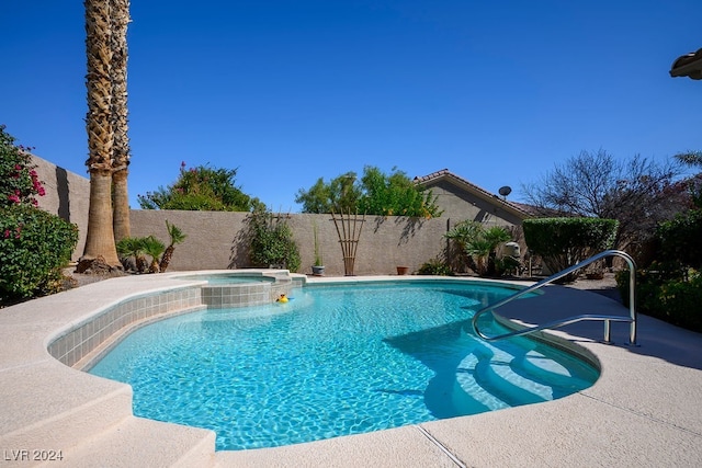 view of pool featuring an in ground hot tub