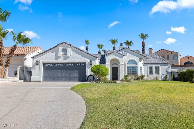 mediterranean / spanish-style house with a garage and a front lawn