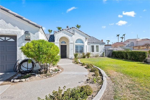 view of front of house featuring a garage and a front lawn