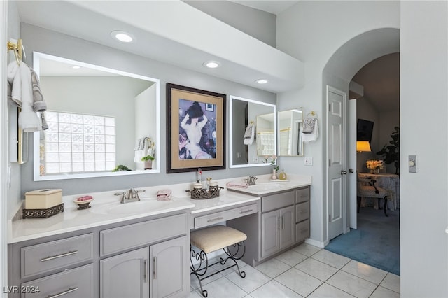 bathroom featuring lofted ceiling, vanity, and tile patterned floors