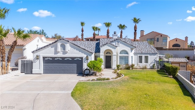 mediterranean / spanish-style home with a garage and a front lawn