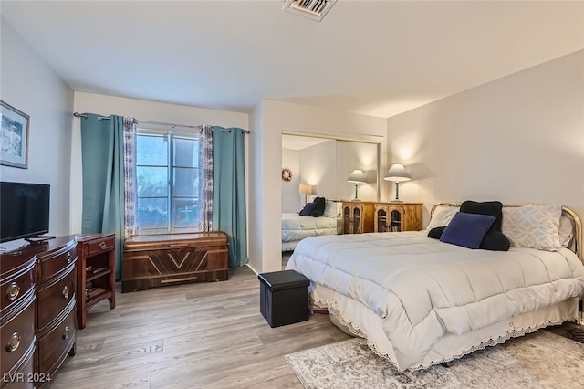 bedroom featuring light hardwood / wood-style flooring and a closet