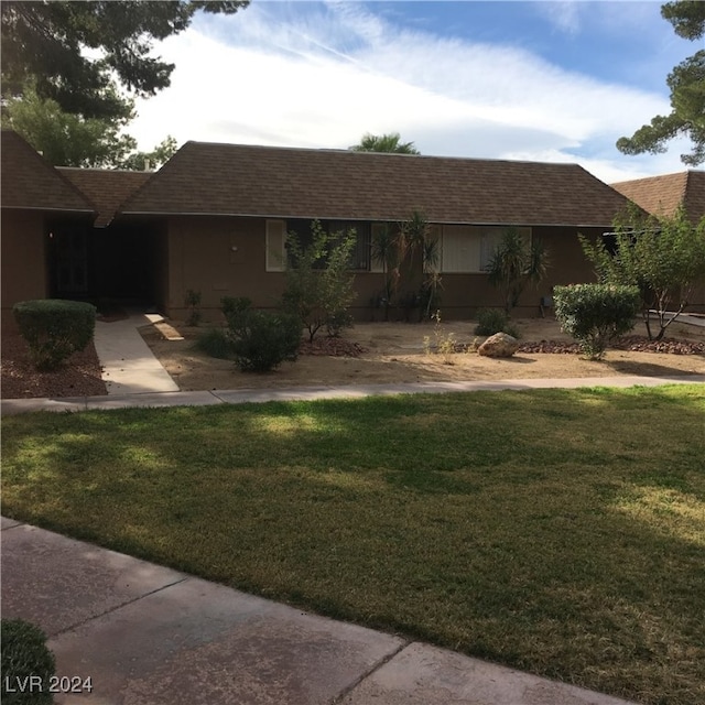 ranch-style house with a front lawn