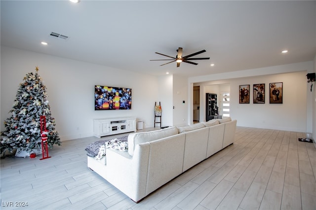 living room with light hardwood / wood-style floors and ceiling fan